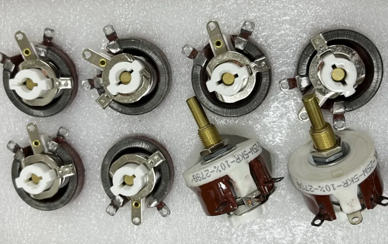Eight wirewound potentiometers, including two complete units and six with exposed resistance windings and metal wipers, showing the internal structure and adjustment mechanism.